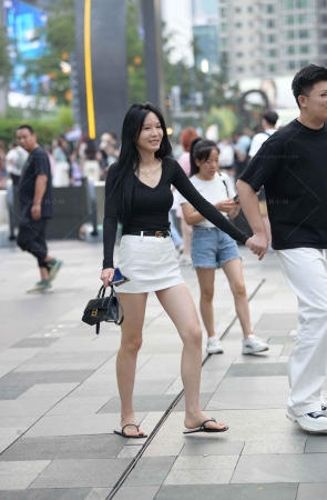 街拍穿人字拖白短裙小女友