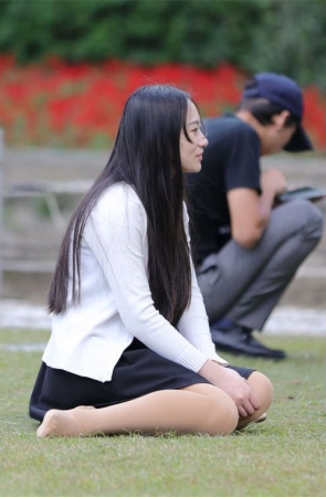 No1676 恬静女生端坐草坪，露出一只长丝足